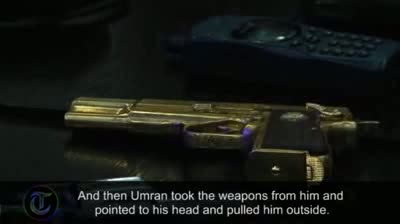 Watch Colonel Gaddafi's captors display his guns Video