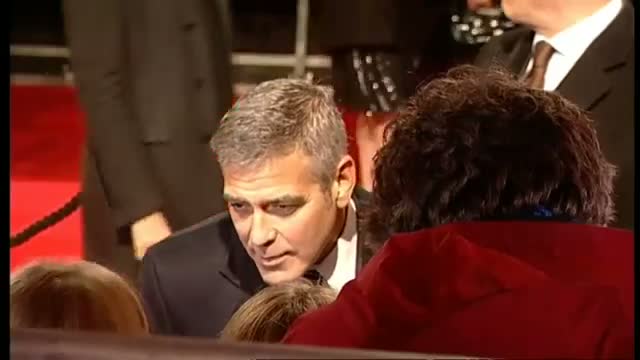 Watch George Clooney tells Brad Pitt to watch his back on BAFTAs red carpet Video