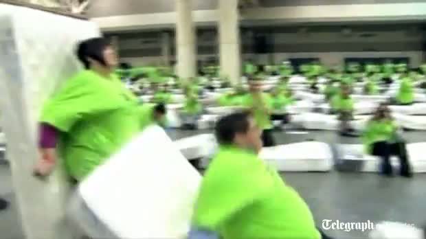 Watch Human mattress dominoes attempt breaks world record Video