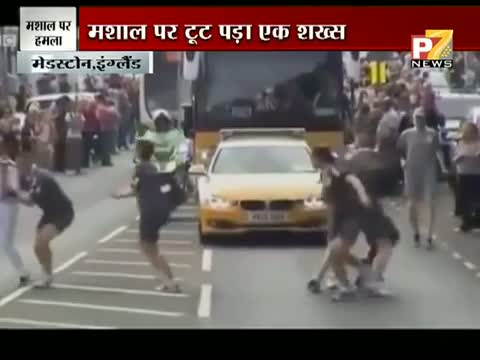 Watch Man tries to Grab Olympic Torch off a Woman Runner in Gravesen Video