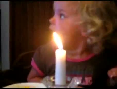 Watch Little girl has hard time blowing out candle Video