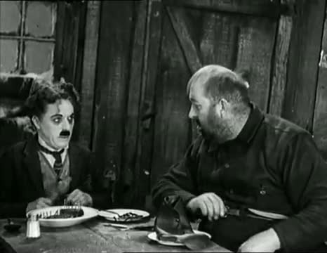 Watch Charlie Chaplin eating his shoe - The Gold Rush (High Quality) Video