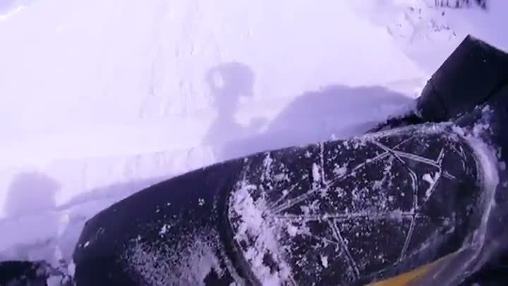 Watch Dude Cheats Death On a Cliff with a Snowmobile Video