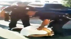 Watch Cop Tries To Stop Another Cop From Hurting Handcuffed Man Video