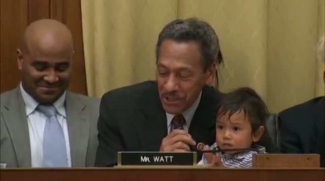 Watch Congressman Balances Questions, Kid on Lap Video
