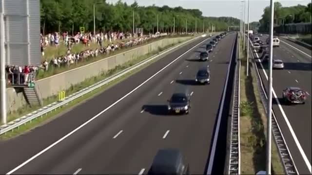 Watch Mourners Gather As MH17 Bodies Transported Video