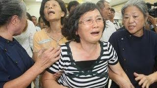 Watch Families Travel to Taiwan Plane Crash Site Video