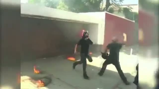 Watch Protesters Hurl Fire-bombs at Govt Building Video