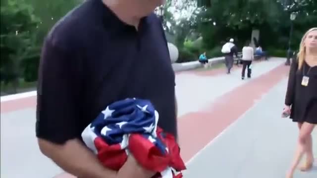 Watch Protest against racism in NY sets American flag on fire Video