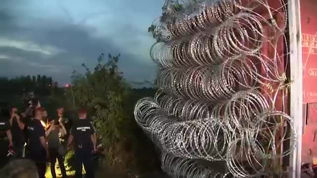 Watch Hungary Blocks Border Gap with Razor Wire Video