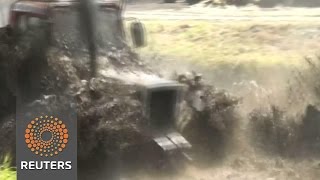 Watch Drivers compete in Russian tractor races Video