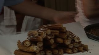 Watch Pamplona festival goers queue for rare churros treat Video