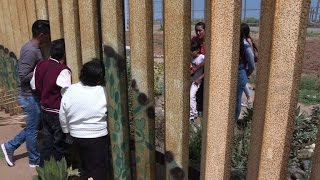 Watch Mexican families reunite at the border wall that divides them Video