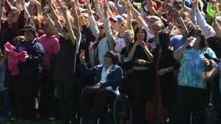 Watch Human Peace Sign For John Lennon's 75th Birthday Video