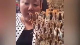 Watch Stomach-Churning Moment Woman Eats Dozens of LIVE Scorpions in Chinese Food Market Video